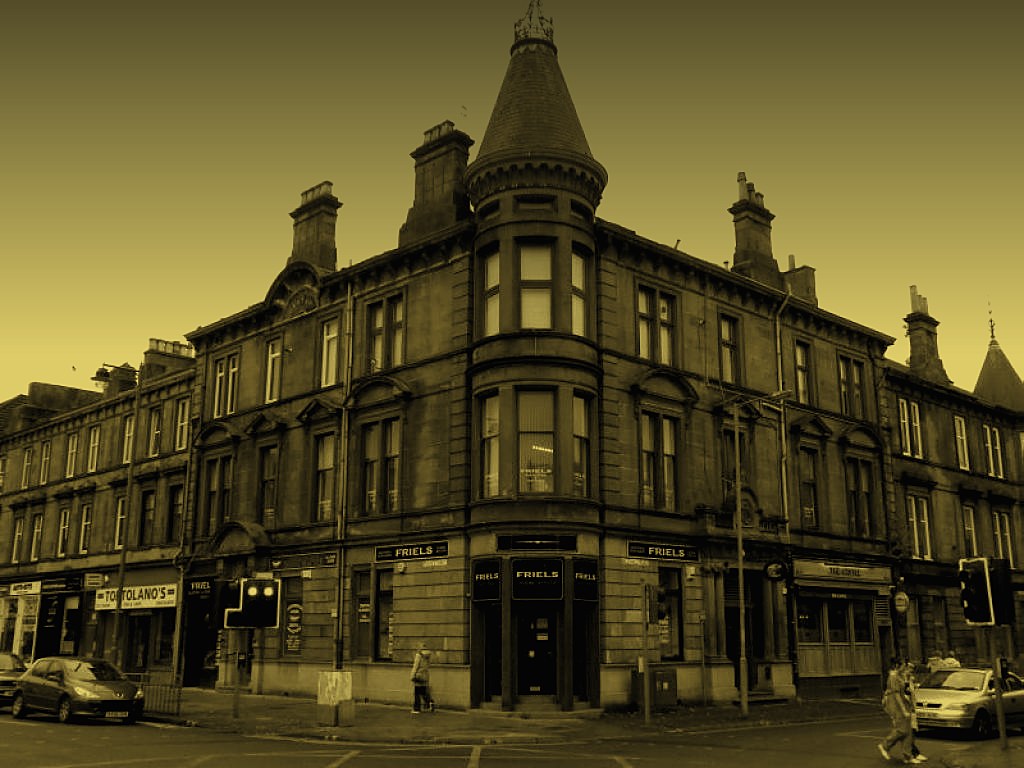 Friels office at The Cross, Uddingston: a Victorian sandstone corner building with a turret and FRIELS signage over the door